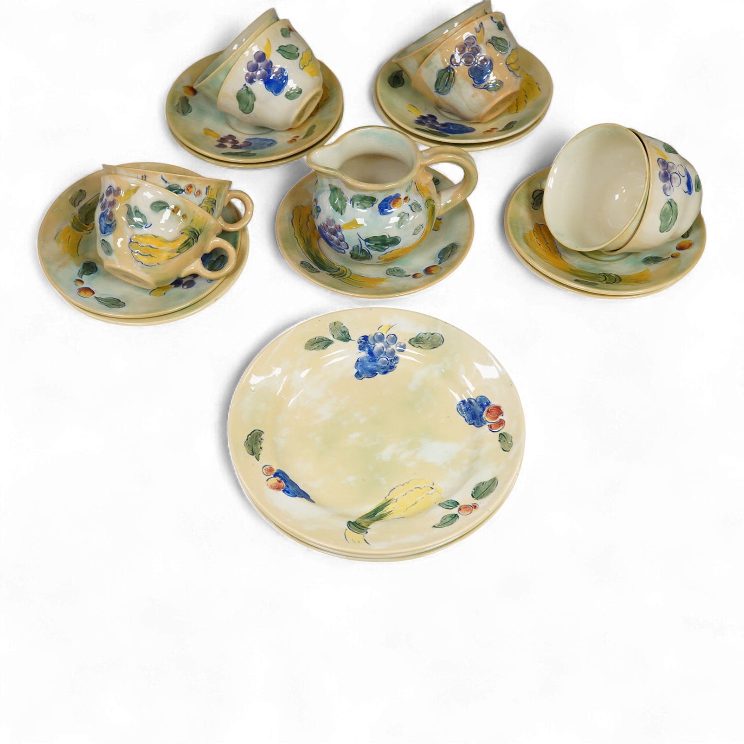 A collection of Doulton Brangwynware to include cups and saucers and a milk jug, largest 19cm in diameter